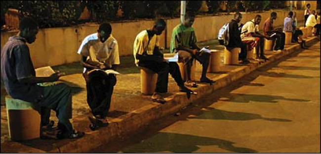 Students in Africa Study in an Airport Streelight